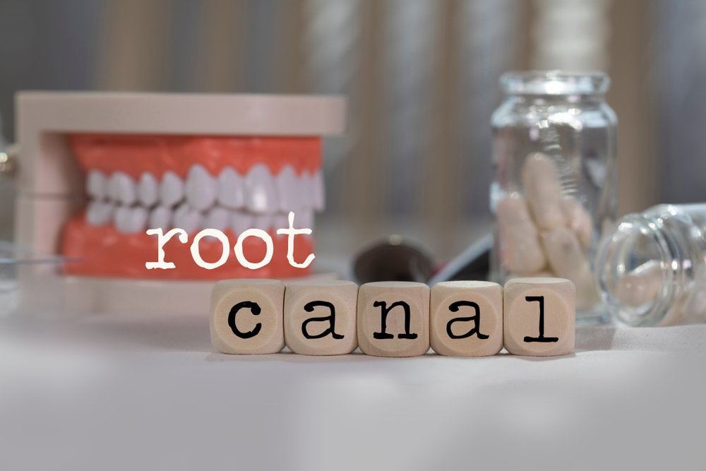 Root canal written out in letter boxes on a dentist's table.